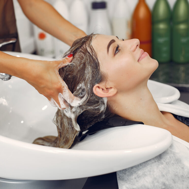 Woman washing head in a hairsalon